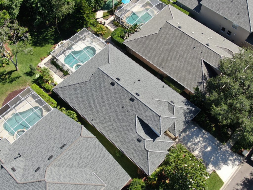 aerial view of a neighborhood where houses have new shingle roofs