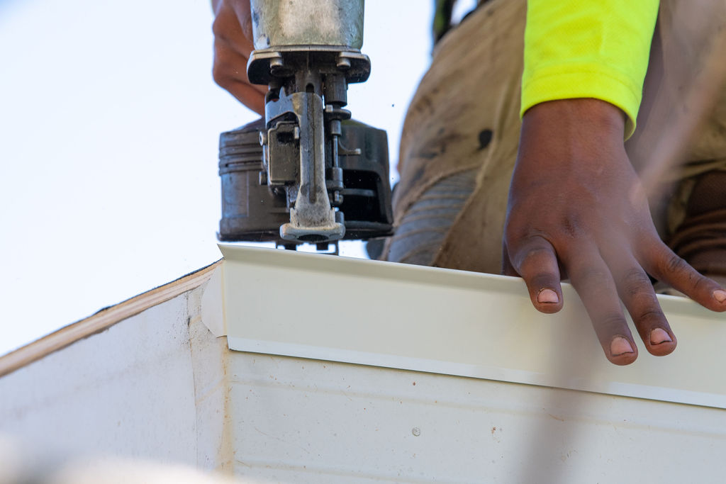 close up of roofer installing roofing materials