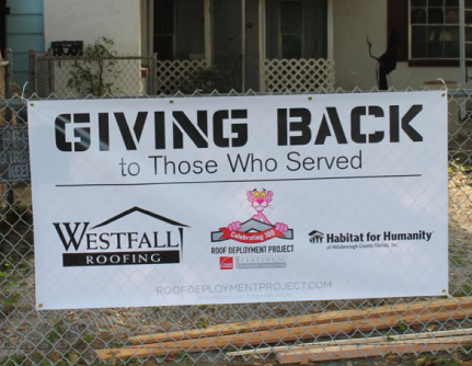 sign saying Giving Back to Those Who Served - Westfall Roofing, Owens Corning Roof Deployment Project, Habitat for Humanity